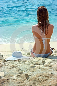 Brunette girl relaxing in water on the beach