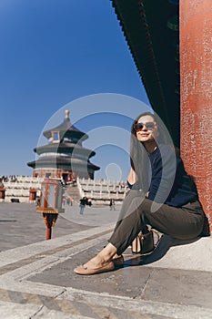 brunette girl sitting on the steps by temple of heven in China