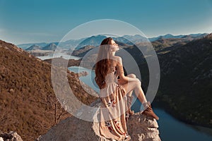 Brunette girl tourist in beige dress sightseeing of Rijeka Crnojevica, Montenegro. Skadar lake national park, Pavlova Strana. Vie