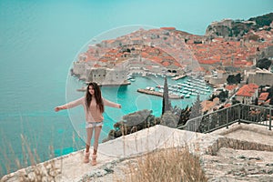 Brunette Girl tourist visiting mountain viewpoint sightseeing i