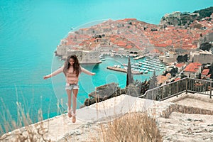 Brunette Girl tourist visiting mountain viewpoint sightseeing i