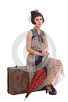 Brunette girl with umbrella and suitcase