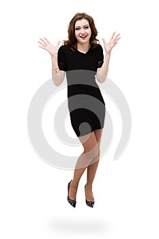 Brunette girl wearing a dress jumping