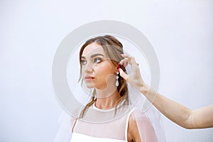 Brunette girl in a wedding dress Bride in a white dress. Makeup. photo