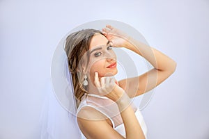 Brunette girl in a wedding dress. Bride in a white dress. Makeup. photo