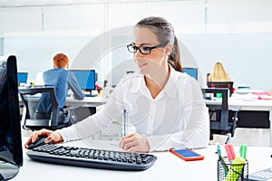 Brunette glasses businesswoman working in office