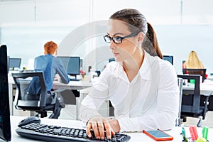 Brunette glasses businesswoman working in office