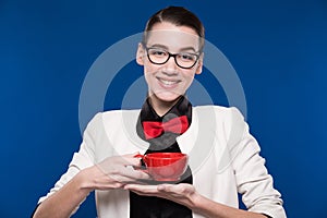 Brunette in glasses with a cup in his hands