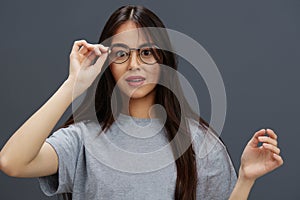 Brunette glasses on face fashion lifestyle gray t-shirt Gray background