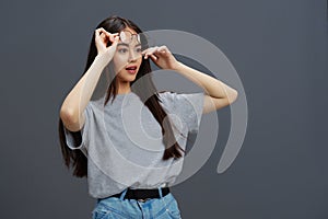 Brunette glasses on face fashion lifestyle gray t-shirt Gray background