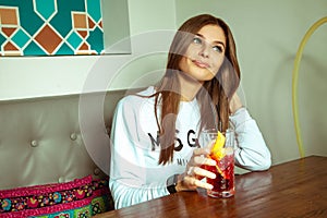 Brunette with green eyes posing in the cafe