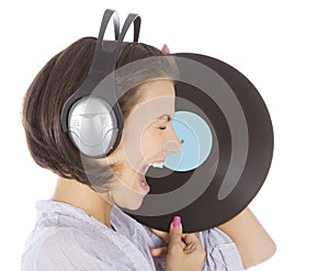 Brunette in headphones with vinyl record ov