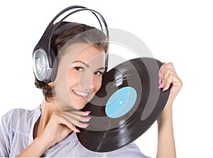 brunette in headphones with vinyl record over white
