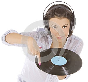 Brunette in headphones with vinyl record over white