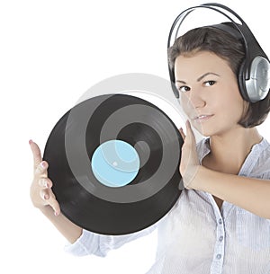 Brunette in headphones with vinyl record over white