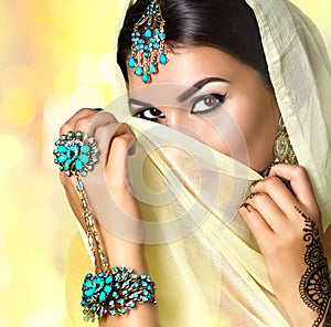 Brunette Indian woman portrait. Indian girl in sari with mehndi