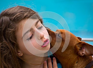 Brunette kid girl and dog pet whispering ear