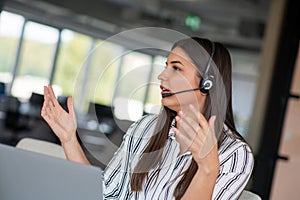 Brunette Lady Video Calling On Laptop Wearing Headphones Smiling And Waving Hand To Webcam Communicating Online