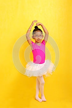 Brunette Latina girl with autism spectrum disorder (ASD) takes ballet dance therapy to express herself and communicate
