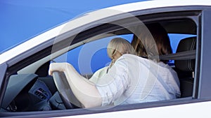 Brunette man and blonde woman get into an accident while travelling by car against chroma key background. They are