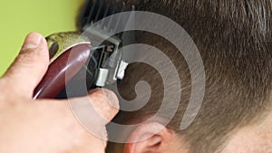 brunette man getting his hair cut with clippers