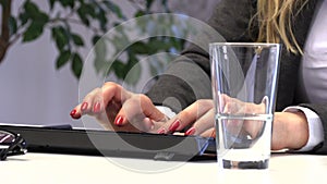 Brunette Manager pours water into a glass for drinking