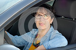 Brunette mature woman driving car