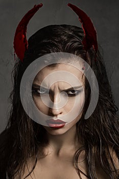 Brunette model with devil horns