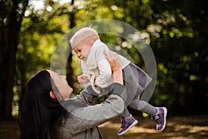 Brunette mother playing with a cute baby daughter