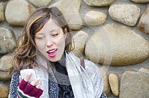 Brunette reading a text message on her smart phone