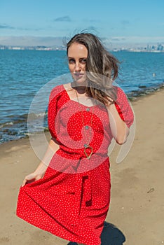 Brunette in red on a beach