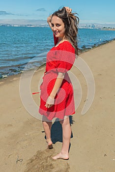 Brunette in red on a beach