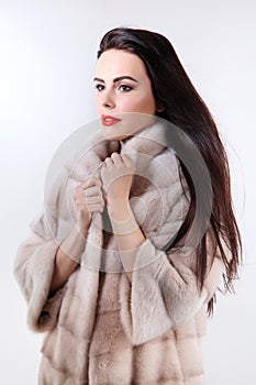 Brunette with red lipstick in light fur coat