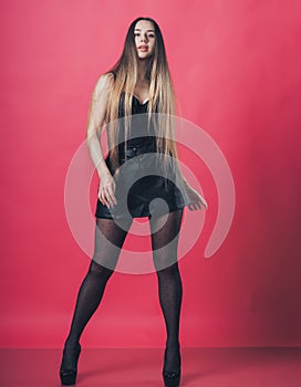 Brunette sexy girl posing at the pink background