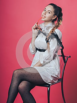 Brunette sexy girl posing at the pink background