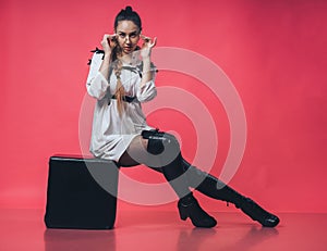 Brunette sexy girl posing at the pink background