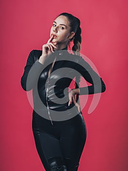 Brunette sexy girl posing at the pink background