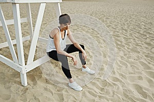 Brunette with short haircut sitting on volleyball seat