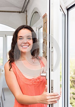 Brunette staying near plastic windows