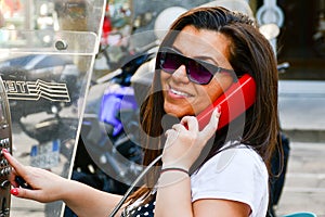 Brunette talking at Public phone box