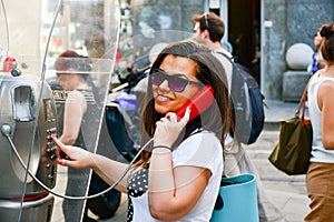 Brunette talking at Public phone box