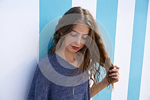 Brunette teen girl portrait in blue stripes wall