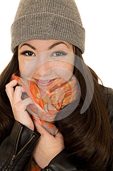 Brunette teen model snuggling her hat and beanie