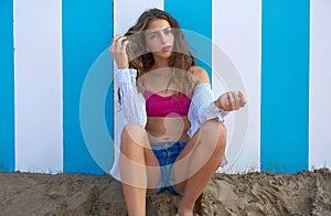 Brunette teen summer girl in blue stripes wall