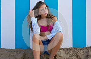 Brunette teen summer girl in blue stripes wall