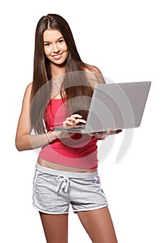 Brunette teenager with laptop on white background