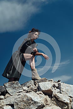 Brunette of trendy woman hiking on the rocks