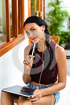 Brunette ukrainian woman artist and illustration drawing, using electronical tablet and stylus
