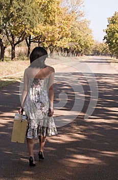 Brunette walking with suitcase