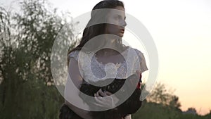 Brunette In White Dress With On Hands With A Hard Look Straightly Looking Into Camera And then Turns Off